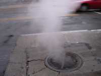 A steaming street grate