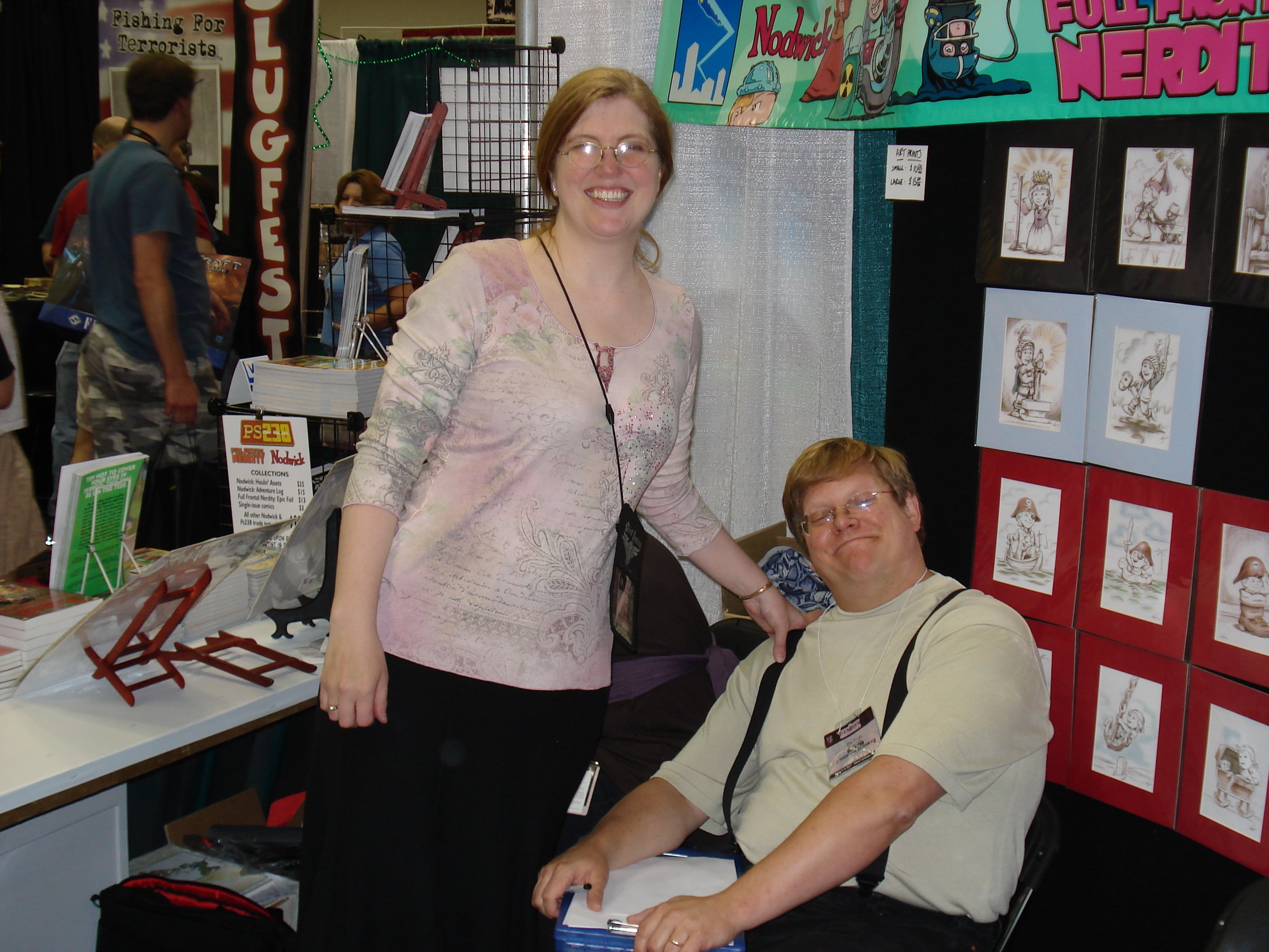 The Foglios: Kaja (left, standing) and Phil (right, sitting)