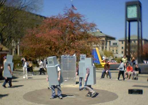 People in cardboard robot outfits protesting