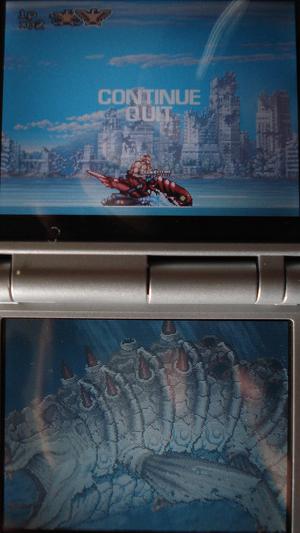 On the top screen our hero rides a futuristic jet ski across the ocean.  On the lower, a bony sea serpant swims by.