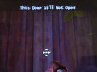 Screenshot: A door. A game message reads 'This Door Will Not Open'