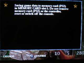 Screenshot: Save dialog reading, 'Saving game data to memory card (PS2) in MEMORY CARD slot 1. Do not remove memory card (PS2) or the controller, reset or switch off the console.'
